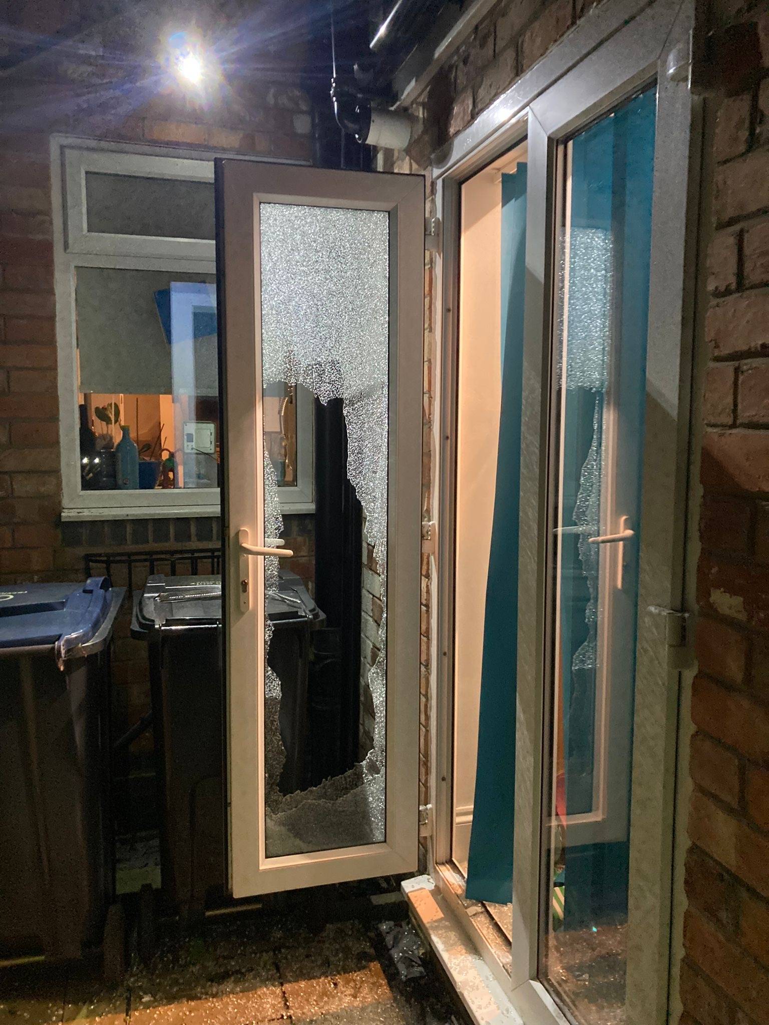 Brand new window door fitted on a red brick house at night time.