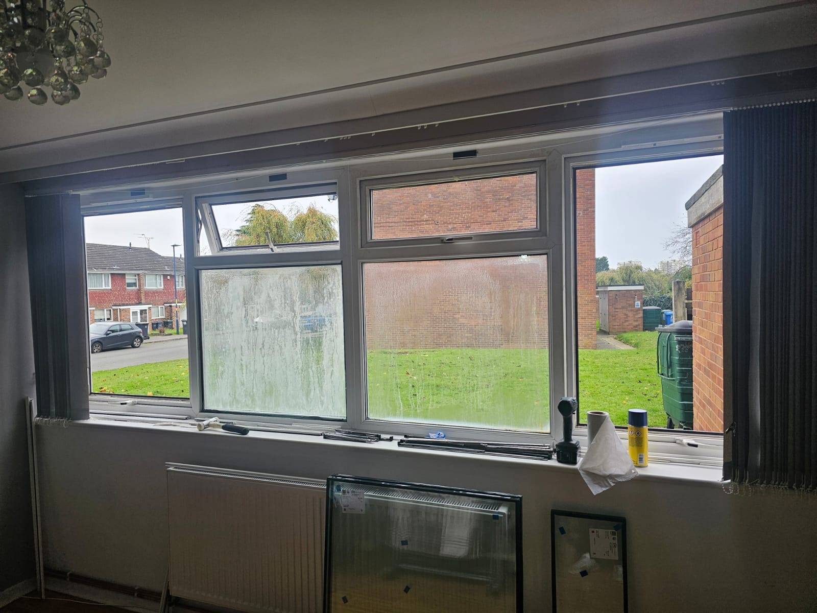 New windows being fitted on a house with front facing windows.
